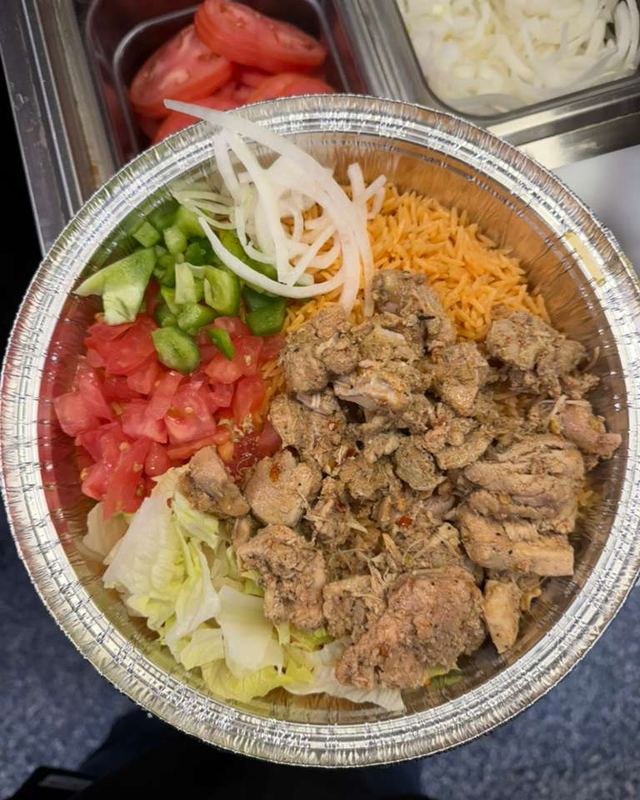 Rice bowl with lettuce, tomato, green peppers and onion