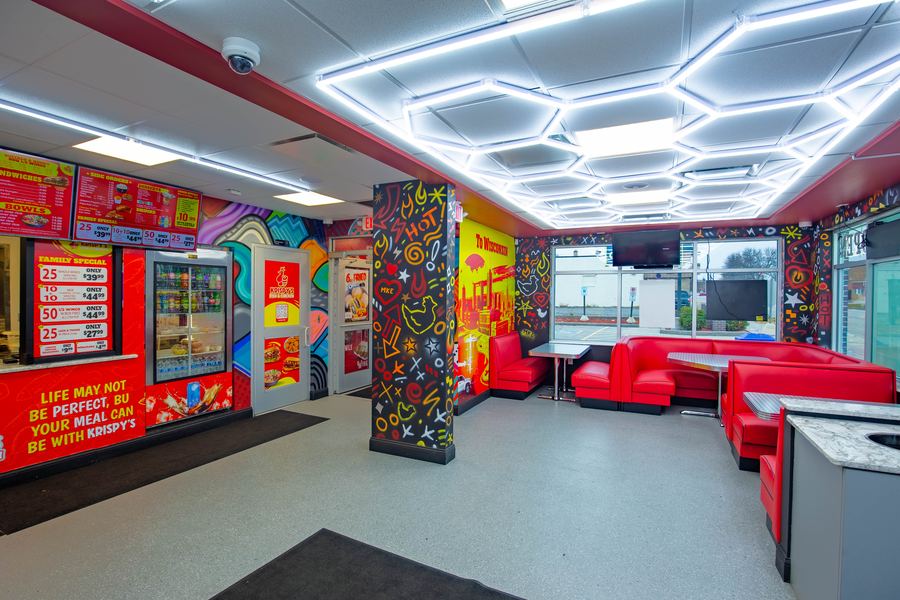Red booths under the honeycomb light ceiling
