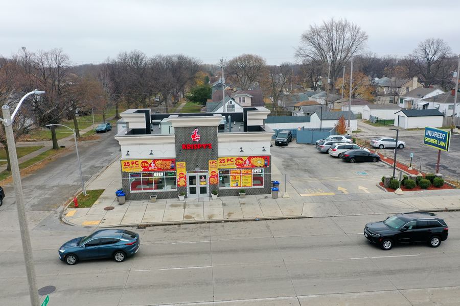 Krispy's seen from across W Capitol Drive, traffic passing
